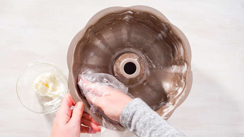 Hand greasing Bundt pan