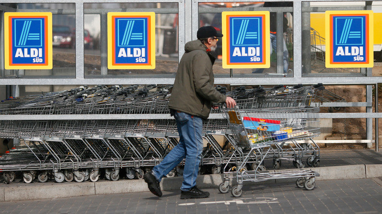 Man grabbing an Aldi shopping cart